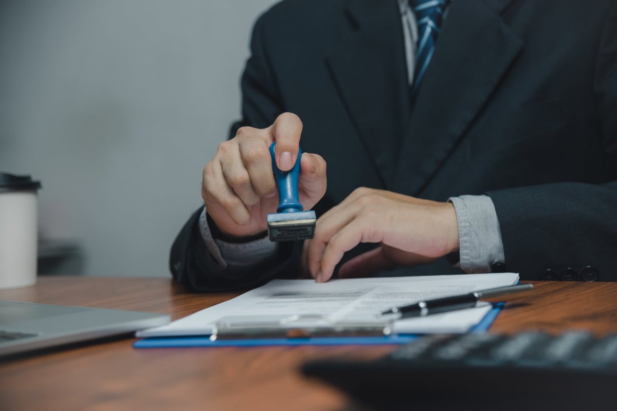 Notary professionally stamping and approving an important financial document
